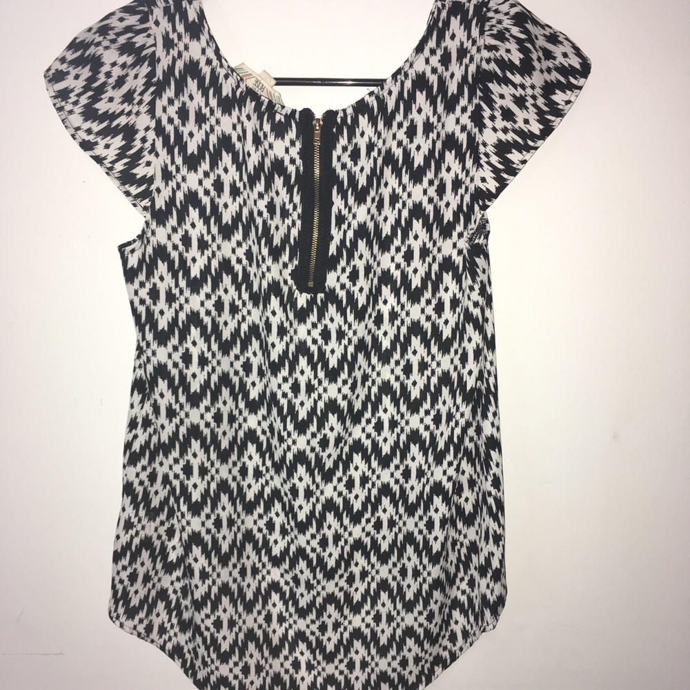 Black and white blouse with gold zipper.